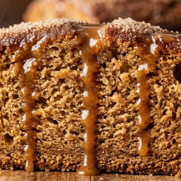 Ultra close-up macro of tender glazed apple cider donut cake loaf with warm spiced cider drizzle
