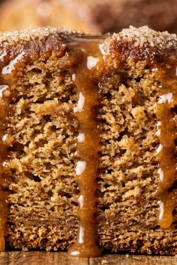 Ultra close-up macro of tender glazed apple cider donut cake loaf with warm spiced cider drizzle