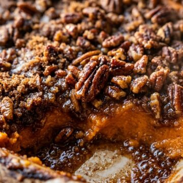 Baking dish of sweet potato casserole with caramelized brown sugar pecan streusel crust