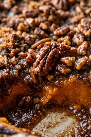 Baking dish of sweet potato casserole with caramelized brown sugar pecan streusel crust