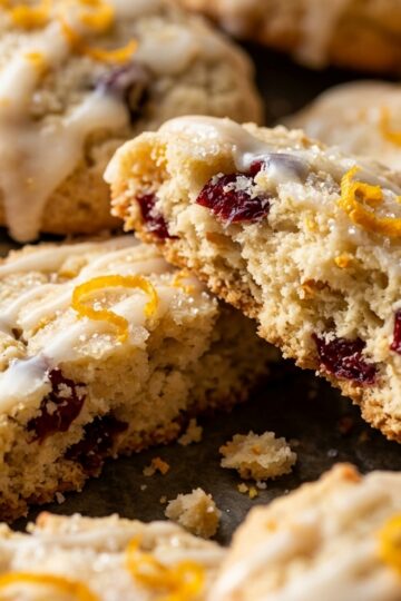 Melt-in-mouth cranberry orange glazed shortbread cookies broken in half
