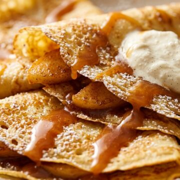 Ultra close-up macro of French apple cinnamon crepes folded into triangles with salted caramel