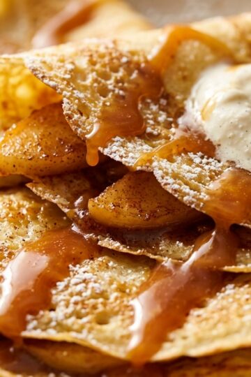 Ultra close-up macro of French apple cinnamon crepes folded into triangles with salted caramel