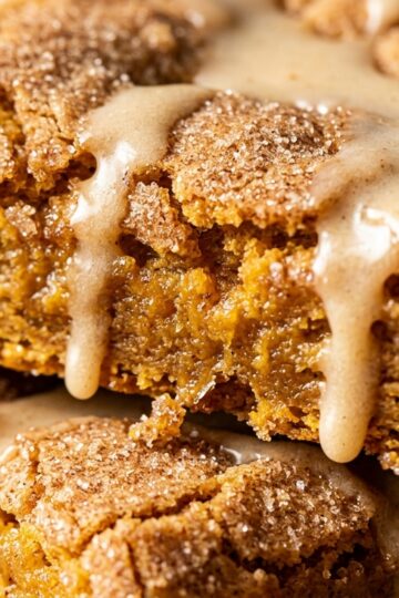 Thick chewy spiced pumpkin snickerdoodle cookie bars with crackled cinnamon sugar crust