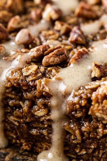 Ultra close-up macro of spiced gingerbread baked oatmeal slice with vanilla glaze