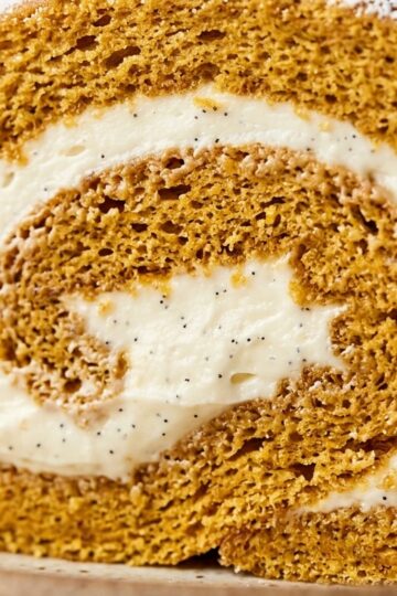 Ultra close-up macro sliced spiced pumpkin roll with vanilla cream cheese filling