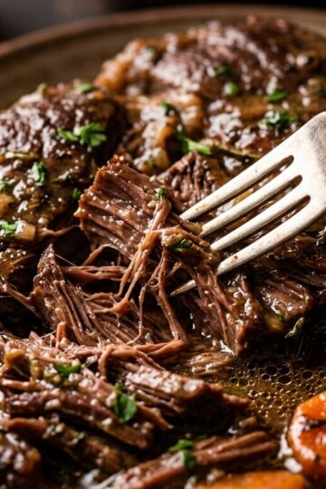 Ultra close-up macro succulent slow cooker beef pot roast with carrots and potatoes